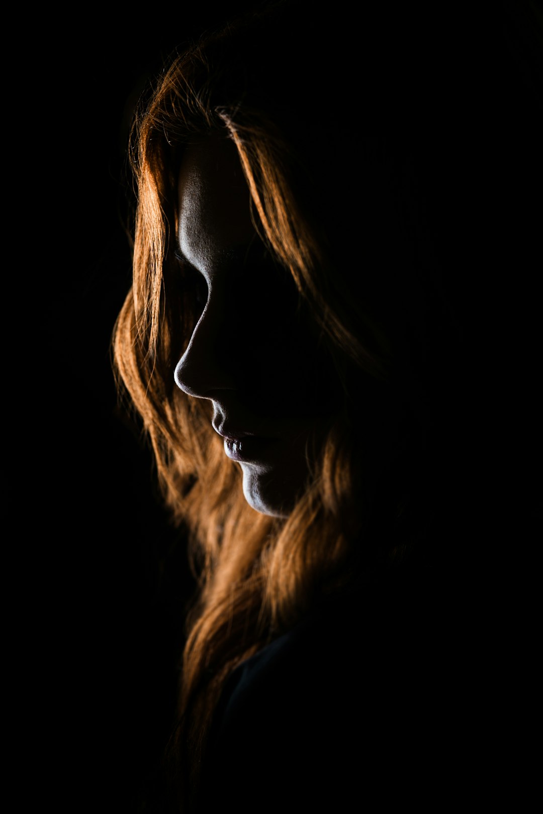 Dramatically lit portrait with defined shadow and sculpted facial contours