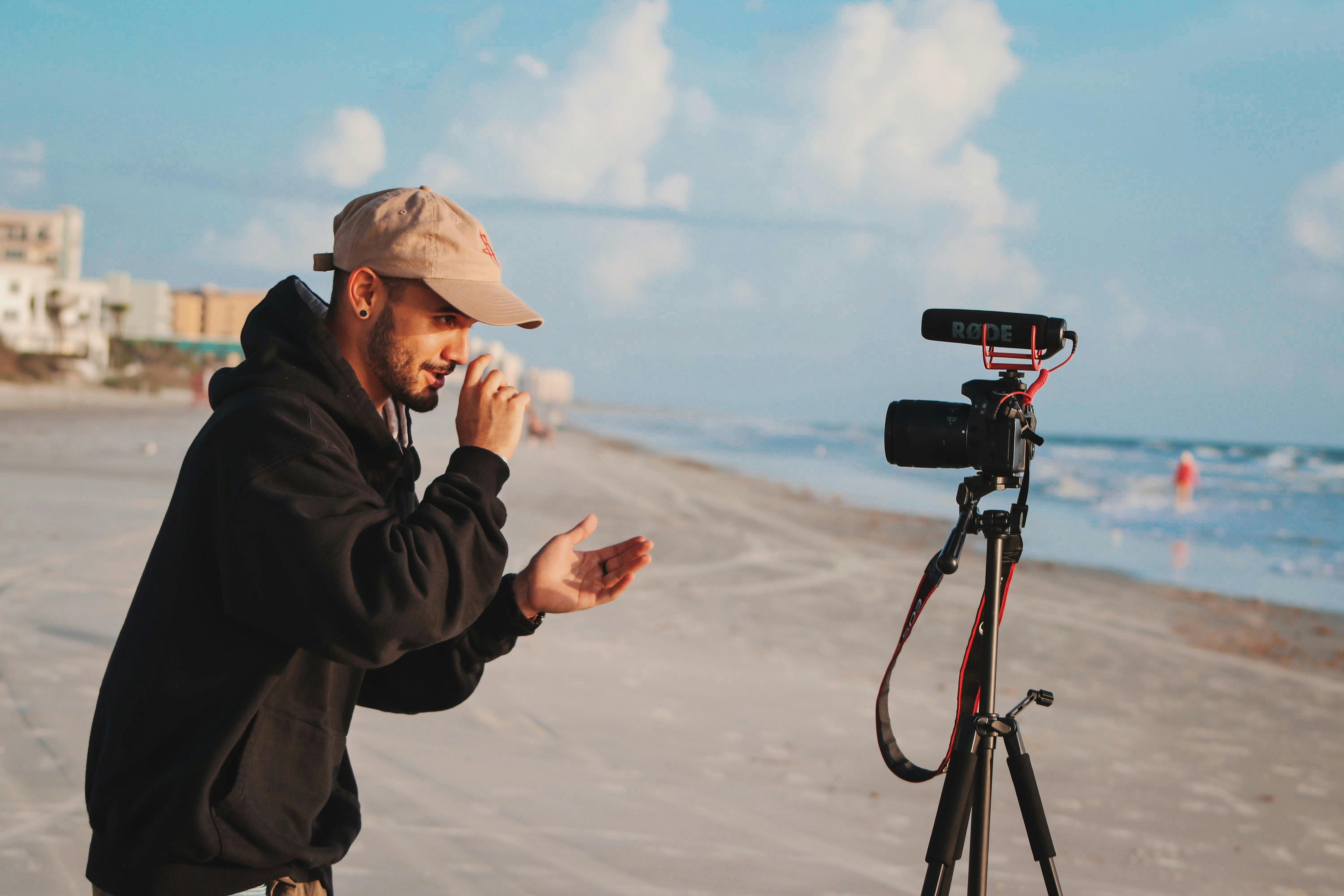 Content creator filming himself with a camera and tripod outdoors