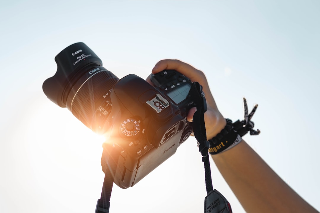 A photographer holding up a camera to take a picture